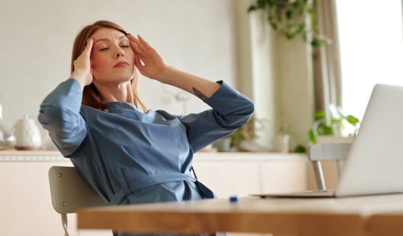 A woman taking a pause at her desk